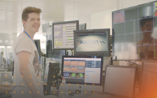 Person watching sports footage on several screens
